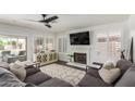 Cozy living room featuring a fireplace, large sectional sofa, and an abundance of natural light at 2438 S Chestnut Pl, Chandler, AZ 85286
