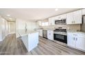 Bright kitchen featuring stainless steel appliances, island and white cabinetry at 2650 W Union Hills Dr # 169, Phoenix, AZ 85027