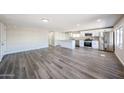 Open-concept living area, showcasing modern kitchen and wood-look floors at 2650 W Union Hills Dr # 169, Phoenix, AZ 85027