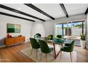 Dining area with modern green chairs, glass table, and stylish decor, perfect for elegant meals at 2801 E Sunnyside Dr, Phoenix, AZ 85028