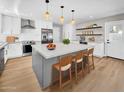 Contemporary kitchen featuring stainless steel appliances, a spacious island, and modern lighting fixtures at 2801 E Sunnyside Dr, Phoenix, AZ 85028