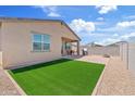 A private backyard with a well-manicured lawn, a patio, and a built-in fire pit, perfect for outdoor entertaining at 2898 E Kim Dr, San Tan Valley, AZ 85143