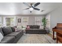 Bright living room with ceiling fan, cozy couches, and ample natural light at 3047 S Mandy St, Mesa, AZ 85212