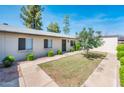 Exterior of a well-kept home with landscaping, featuring a neat lawn and trimmed bushes at 3324 S Parkside Dr, Tempe, AZ 85282