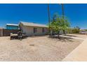 Exterior view of a single story home with gravel landscaping and RV parking at 3447 E Dolphin Ave, Mesa, AZ 85204