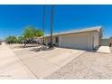 Home featuring a well-maintained front yard, driveway, and attached garage at 3447 E Dolphin Ave, Mesa, AZ 85204