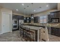 Spacious kitchen featuring dark cabinets, granite countertops, and stainless steel appliances at 3925 E Elmwood St, Mesa, AZ 85205