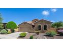 Charming single-story home with a well-manicured front yard and desert landscaping and three-car garage at 3994 E Grand Canyon Pl, Chandler, AZ 85249