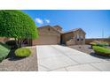 Charming single-story home featuring arched windows, a two-car garage, and well-maintained desert landscaping at 3994 E Grand Canyon Pl, Chandler, AZ 85249