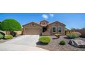 Charming single-story home featuring arched windows, a two-car garage, and well-maintained desert landscaping at 3994 E Grand Canyon Pl, Chandler, AZ 85249