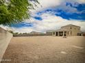 Large backyard with gravel and perimeter block wall, and covered patio at 4061 N 308Th Ln, Buckeye, AZ 85396