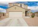 Charming beige home with a two-car garage, concrete driveway, and landscaped front yard at 4061 N 308Th Ln, Buckeye, AZ 85396