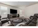 Well-lit living room featuring a television, speakers, and reclining sofas at 4061 N 308Th Ln, Buckeye, AZ 85396