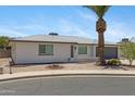 Inviting home with desert landscaping, and a grey two car garage at 4347 E Catalina Cir, Mesa, AZ 85206