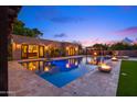 Sparkling pool and patio area with an outdoor fireplace creating a resort-style ambiance at 4518 E Solano Dr, Phoenix, AZ 85018