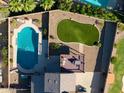 An aerial view of a private pool, backyard with artificial turf and a patio at 4547 E Buist Ave, Phoenix, AZ 85044