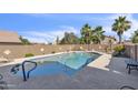 Backyard pool with blue accents, surrounded by a block wall for privacy at 4547 E Buist Ave, Phoenix, AZ 85044