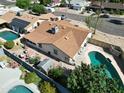 Aerial view of backyard featuring a pool, patio, shed, and partial view of neighborhood at 4623 W Solano S Dr # South, Glendale, AZ 85301