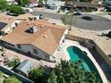 Aerial view of backyard with pool, outdoor patio furniture set, and partial view of neighborhood at 4623 W Solano S Dr # South, Glendale, AZ 85301