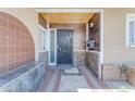 Detailed front porch featuring decorative tile accents, a secure metal door, and a unique stone base at 4632 W Marlette Ave, Glendale, AZ 85301