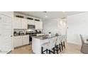 Modern kitchen features white cabinets, granite countertops, a breakfast bar, and stainless steel appliances at 48388 N Duran Way, Gold Canyon, AZ 85118