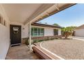 Welcoming covered front porch with desert landscaping and a bench at 527 N Criss St, Chandler, AZ 85226
