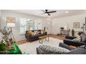 Bright living room with white walls, tile flooring, and a cozy seating area with stylish decor at 527 N Criss St, Chandler, AZ 85226
