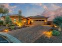 Beautiful home with accent lights, a paver driveway, and well-maintained desert landscaping at 6251 E Bramble Berry Ln, Cave Creek, AZ 85331