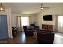 Bright living room with wood flooring, a ceiling fan, and comfortable seating at 6352 W Campo Bello Dr, Glendale, AZ 85308