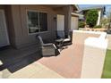 Cozy outdoor patio with brick flooring, comfortable seating, and a relaxing ambiance at 6352 W Campo Bello Dr, Glendale, AZ 85308