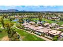 Expansive aerial view of luxury home on golf course with scenic lake and mountain views at 7475 E Gainey Ranch Rd # 22, Scottsdale, AZ 85258