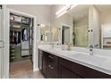 Modern bathroom with double vanity, glass-enclosed shower, and walk-in closet at 820 N 8Th Ave # 14, Phoenix, AZ 85007