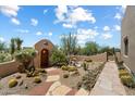 Enclosed courtyard featuring desert landscaping, walkway, garden fountain, and decorative entry gate at 9030 E Trail Dr, Carefree, AZ 85377