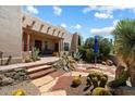 Inviting home exterior with desert landscaping and stone walkway leading to the front entrance at 9030 E Trail Dr, Carefree, AZ 85377