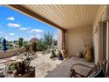 Charming covered patio with stone flooring and decorative pottery, overlooking the private courtyard at 9030 E Trail Dr, Carefree, AZ 85377