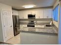 Stylish kitchen featuring stainless steel appliances and sleek granite countertops at 10101 N 91St Ave # 88, Peoria, AZ 85345