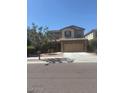 Two-story home with neutral paint, two-car garage, and low-maintenance landscaping at 10335 W Pima St, Tolleson, AZ 85353