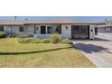 Attractive, single-story home featuring a driveway, manicured lawn, desert landscaping, and an attached garage at 11135 W Cameo Dr, Sun City, AZ 85351