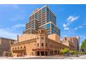 Impressive building exterior showcasing historic architecture and modern design elements against a blue sky at 114 W Adams St # 202, Phoenix, AZ 85003