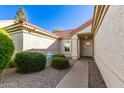 Charming courtyard leading to the front door, surrounded by manicured bushes and a quaint seating area at 1201 E Campbell Ave, Gilbert, AZ 85234