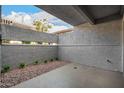 Private outdoor patio with concrete flooring, decorative gravel, and a partial view of surrounding greenery at 1331 W Baseline Rd # 167, Mesa, AZ 85202