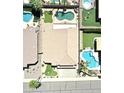 Aerial view of a home's backyard featuring mature landscaping, pools, and a putting green at 15229 S 18Th Dr, Phoenix, AZ 85045