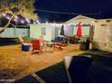 This backyard retreat has string lights, comfortable seating, artificial grass, and a modern fire pit at 1801 N 87Th Pl, Scottsdale, AZ 85257