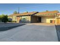 Inviting single-story home with a covered parking area and fresh exterior paint at 1801 N 87Th Pl, Scottsdale, AZ 85257