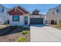 Charming single-Gathering home featuring a two-car garage, contrasting trim, and low maintenance desert landscaping at 18047 W Long Lake Rd, Goodyear, AZ 85338