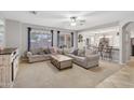 Spacious living room with neutral tones, ample seating, and lots of natural light at 18203 W Port Royale Ln, Surprise, AZ 85388