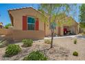 Charming single-story home boasts a well-maintained desert landscape and convenient drive-through garage at 18241 W Foothill Dr, Surprise, AZ 85387