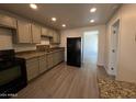 Updated kitchen with granite countertops, black appliances, and wood laminate flooring at 2045 E Orange St, Tempe, AZ 85281