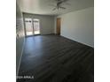Open living space featuring sleek laminate flooring, and a glass sliding door to the back patio at 2045 E Orange St, Tempe, AZ 85281