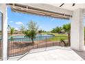 This covered balcony offers beautiful water views of a lake and golf course at 21480 N 56Th Ave, Glendale, AZ 85308